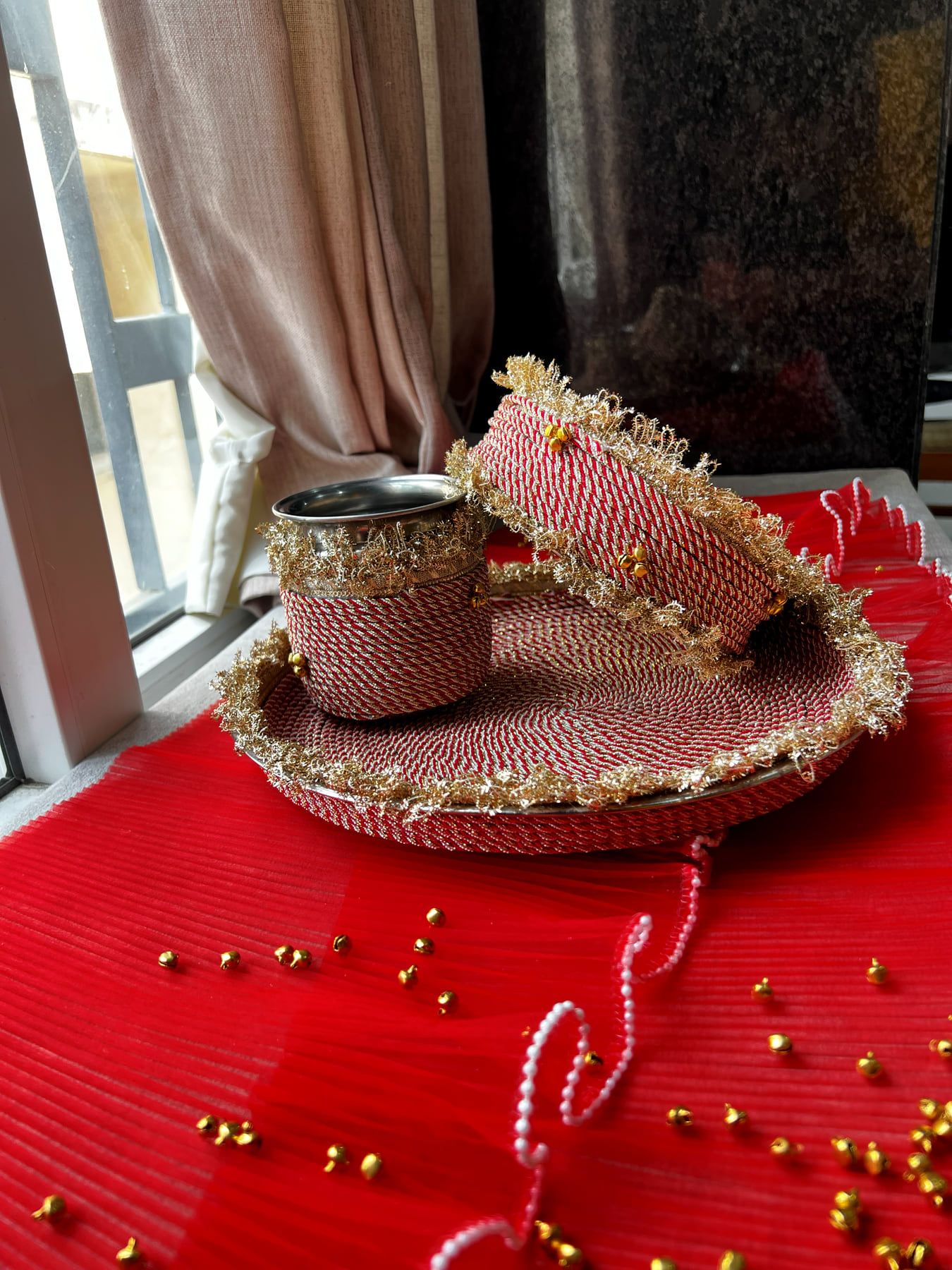 Red and gold Karwa Chauth set from a lower angle with pearl strings